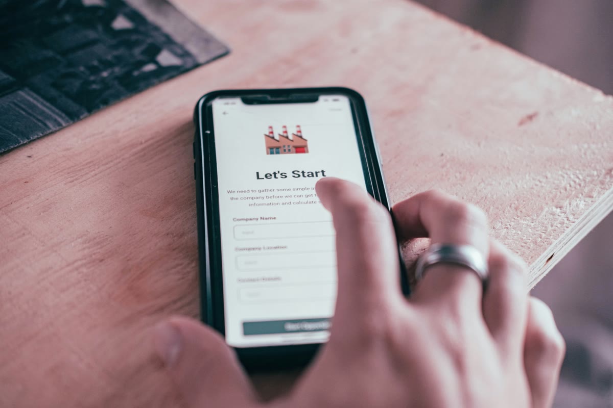 Hand holding a smartphone displaying a getting started screen